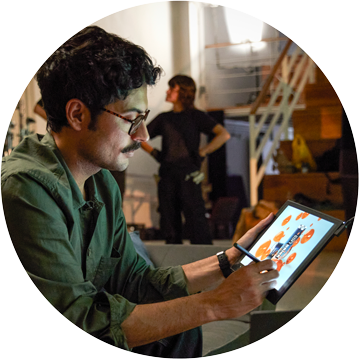 Person working at a desk on a Wacom Movink pen display